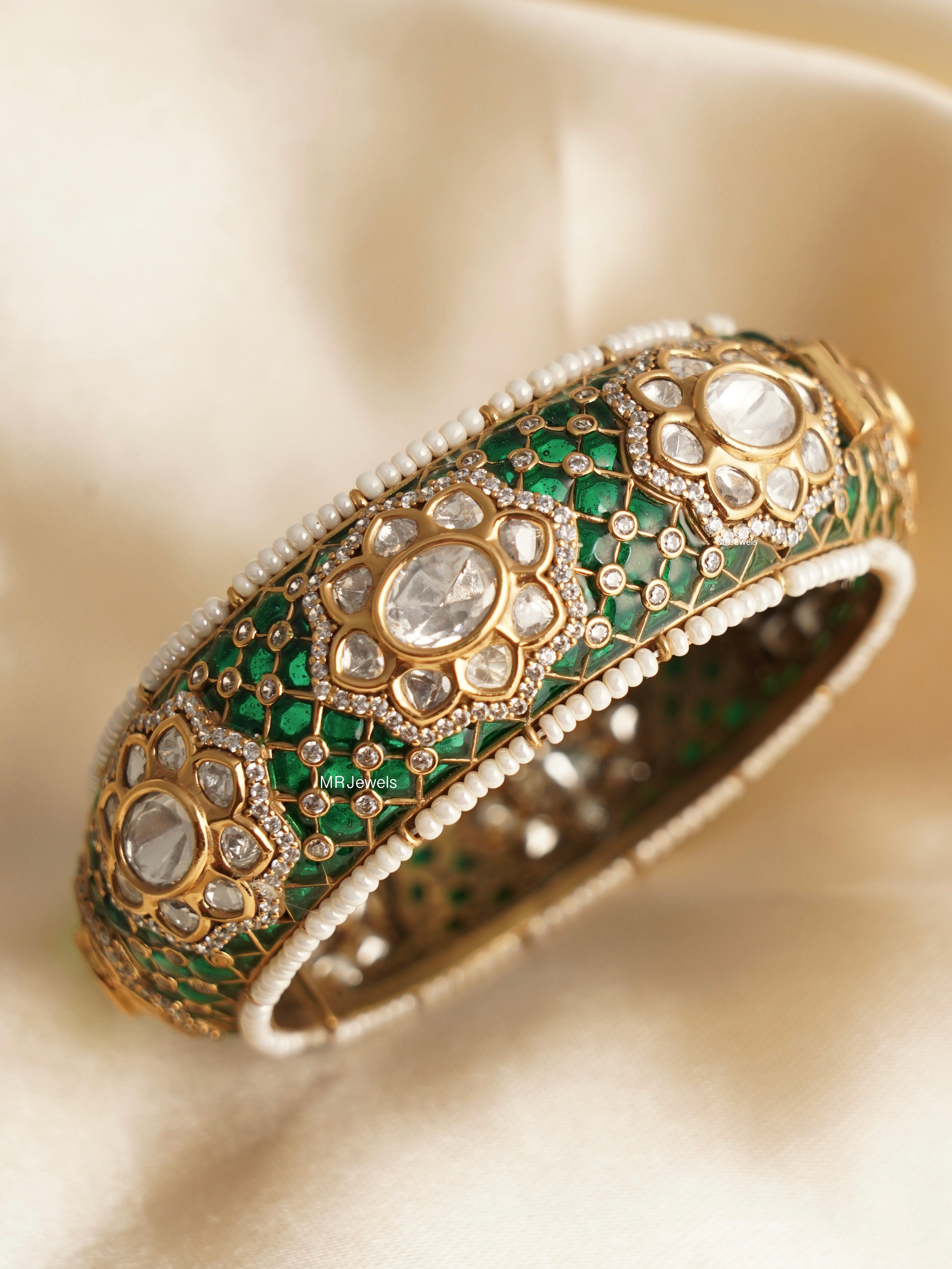 side view of traditional kundan polki kada with intricate enamel accents
